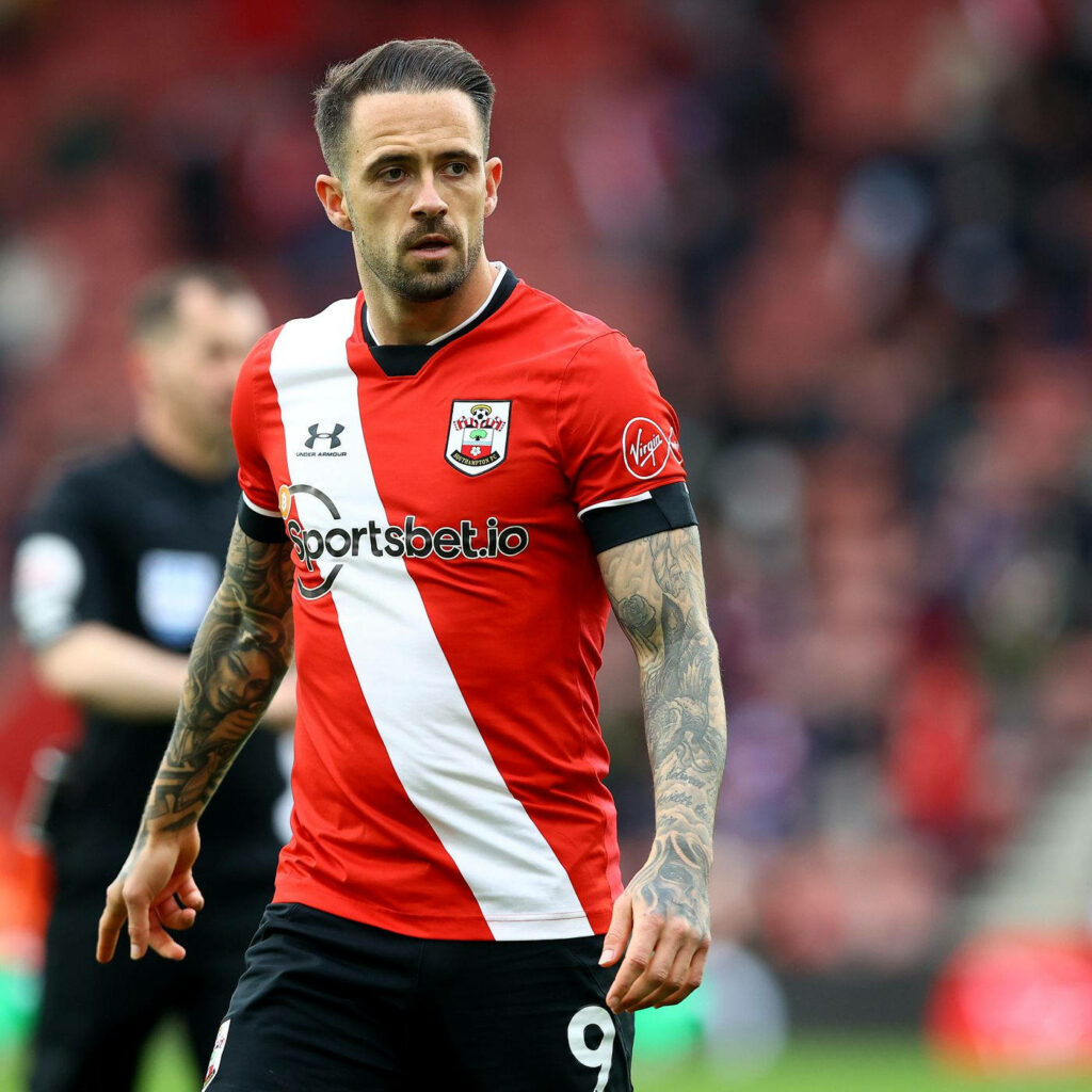 Danny Ings in Southampton FC kit with tattoos focused in stadium wallpaper background