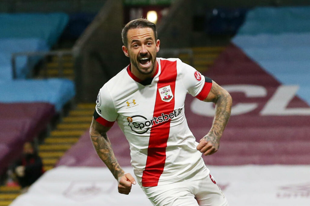 Danny Ings energetic action shot in Southampton kit running on vibrant football stadium pitch wallpaper