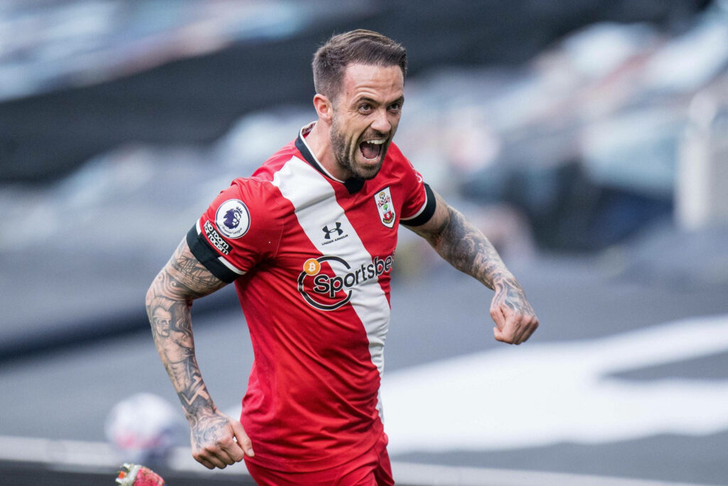 Danny Ings shouting passionately in red and white Southampton kit during intense football match Wallpaper
