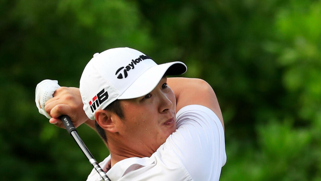 Danny Lee mid-swing golf wallpaper wearing white TaylorMade cap and shirt on lush green course