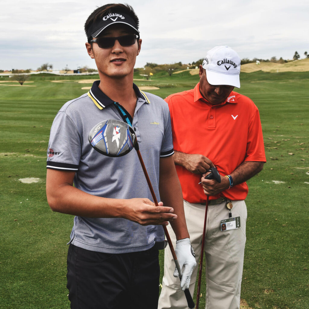 Danny Lee and caddie in sporty attire on lush golf course showing teamwork and focus wallpaper