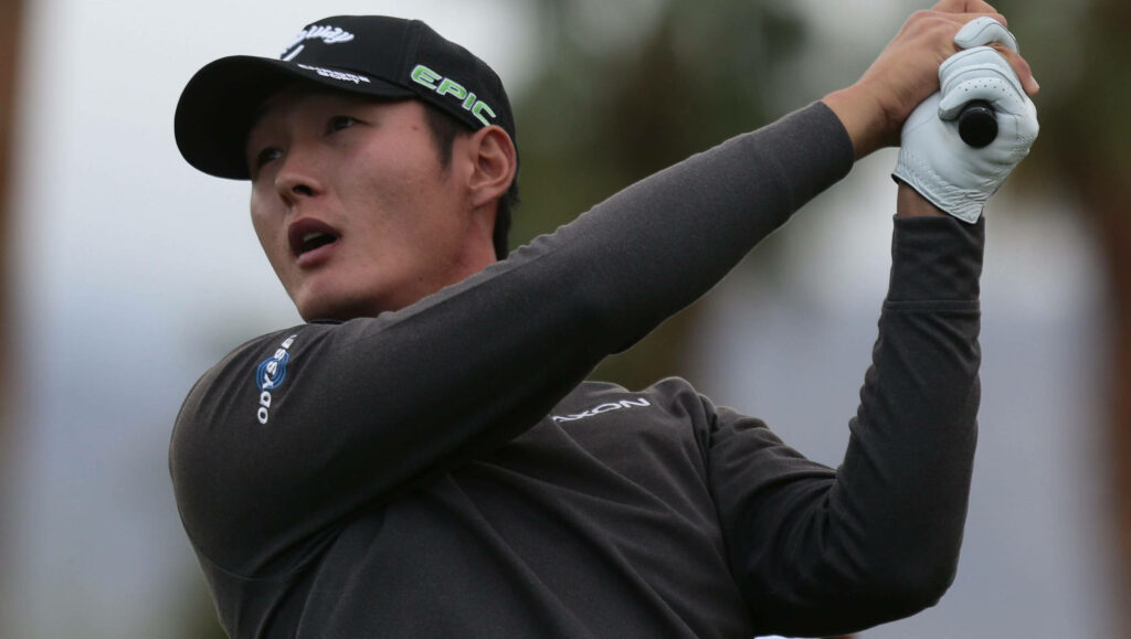 Danny Lee mid-swing professional golfer focused intensity athletic form dynamic outdoor background Wallpaper