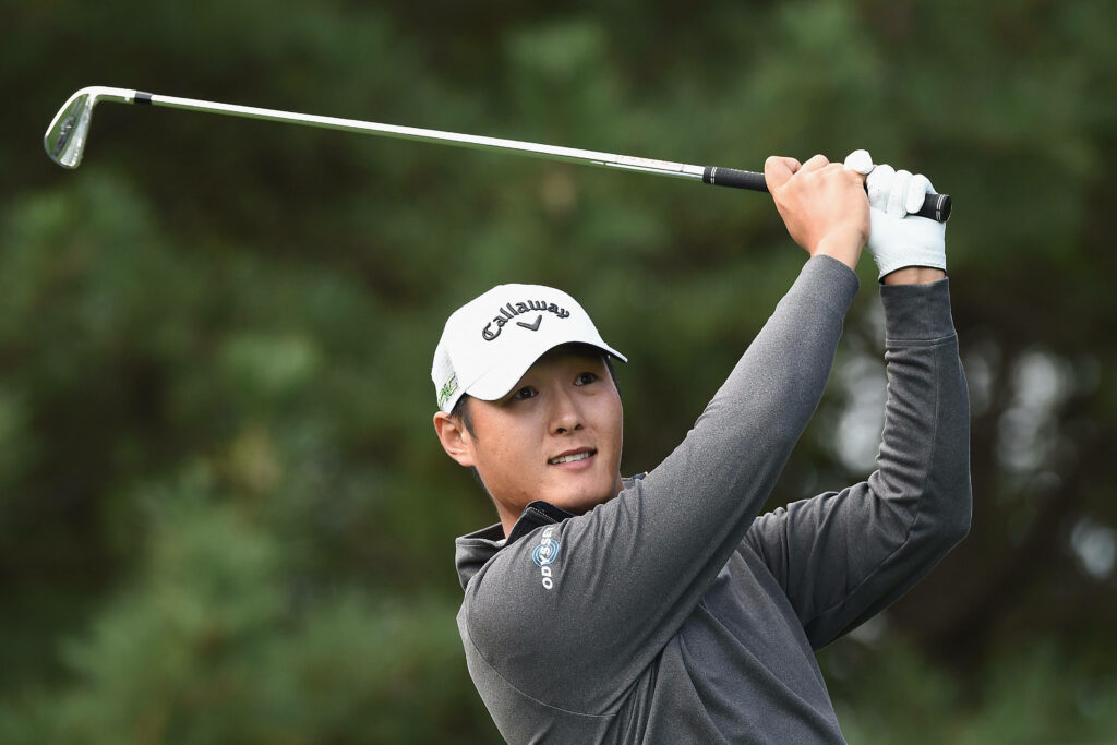 Danny Lee mid swing golf wallpaper with Callaway cap athletic form on lush green outdoor course