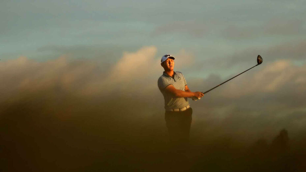 Golfer Danny Lee mid-swing with dramatic sky golden light green foreground sports wallpaper background