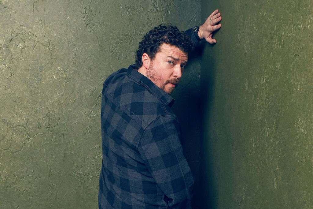 Danny McBride candid pose against textured green wall natural lighting relaxed intense expression wallpaper