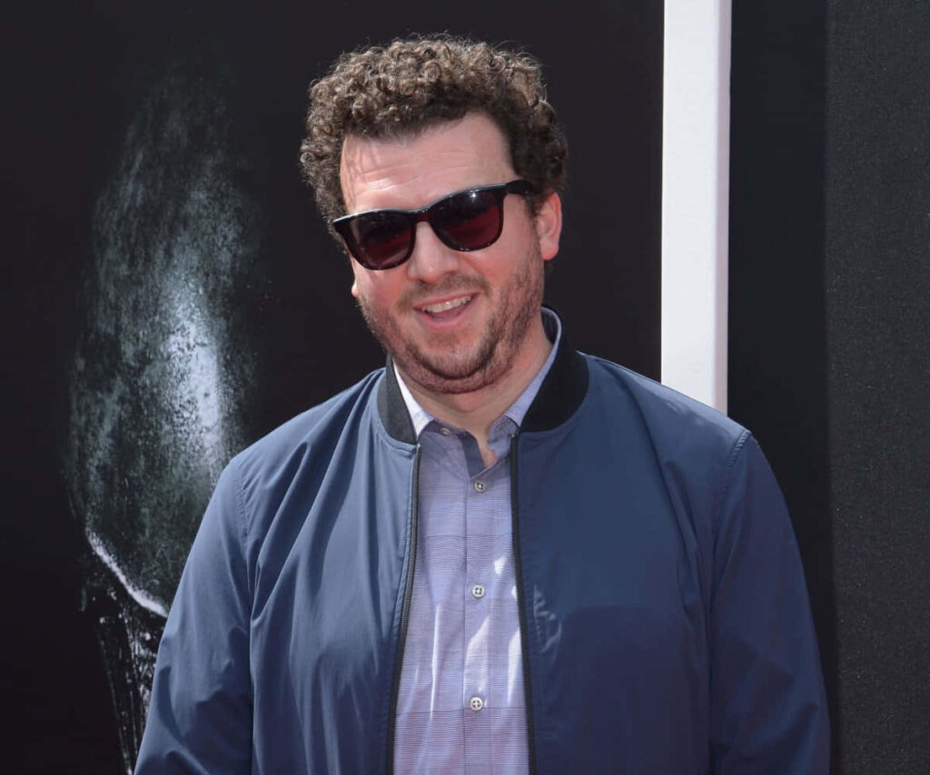 Danny McBride wearing sunglasses blue jacket confident pose dark dramatic wallpaper background