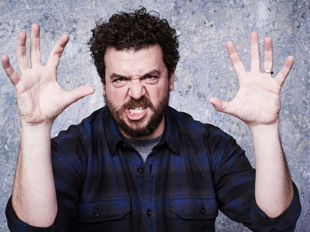 Danny McBride intense pose blue plaid shirt dramatic gesture textured gray background wallpaper