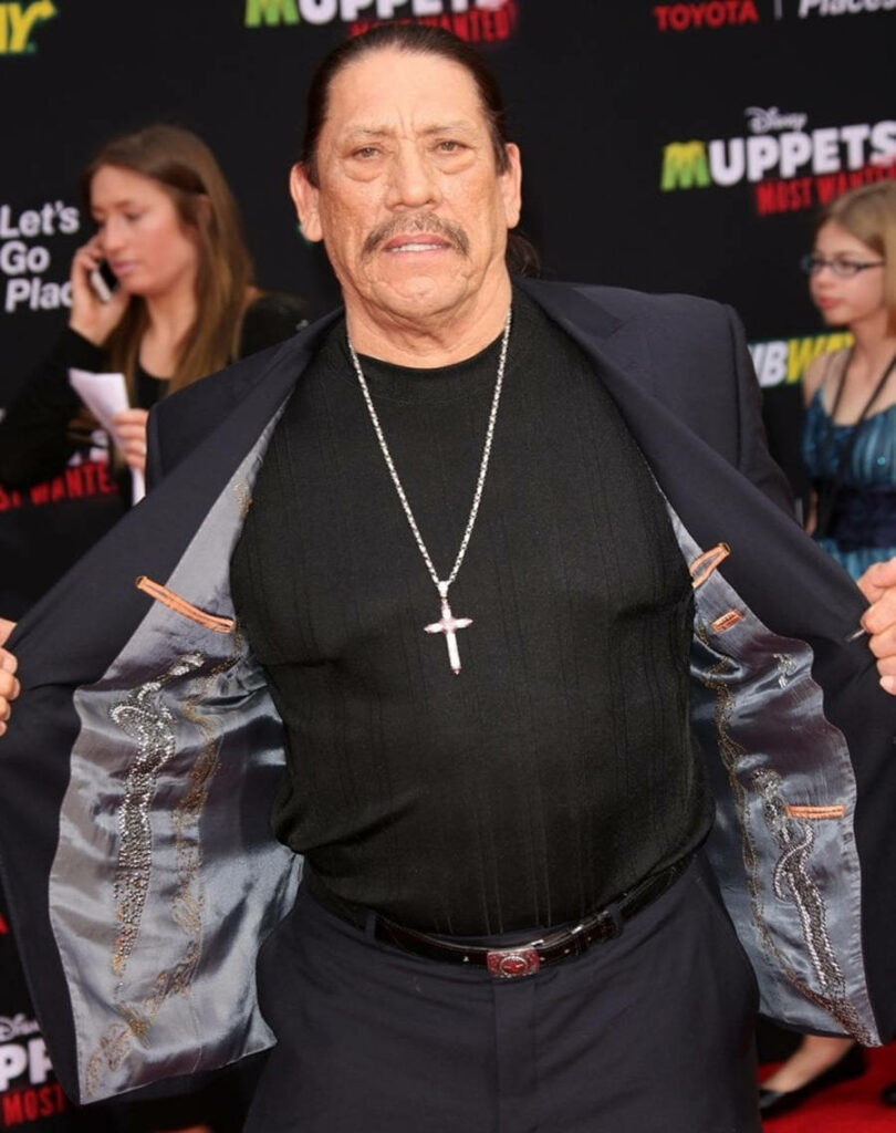 Danny Trejo on red carpet at Muppets Most Wanted premiere wearing black suit and cross necklace Wallpaper