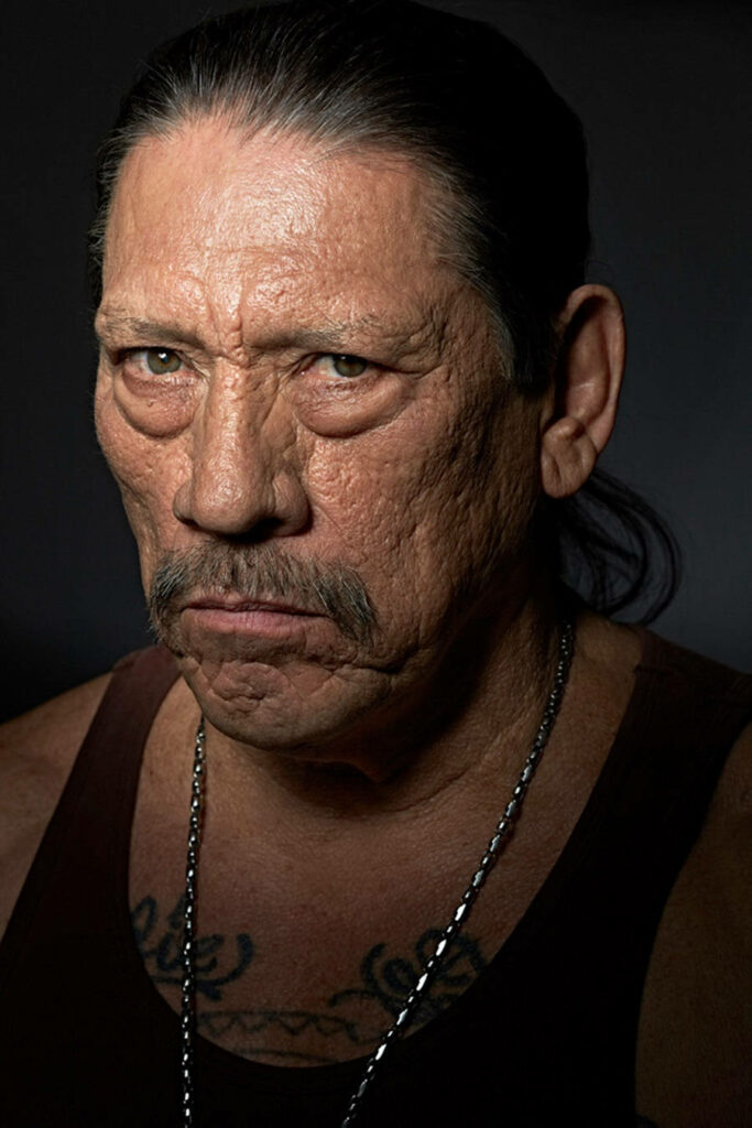 Danny Trejo intense portrait with rugged skin texture and dramatic lighting dark background wallpaper