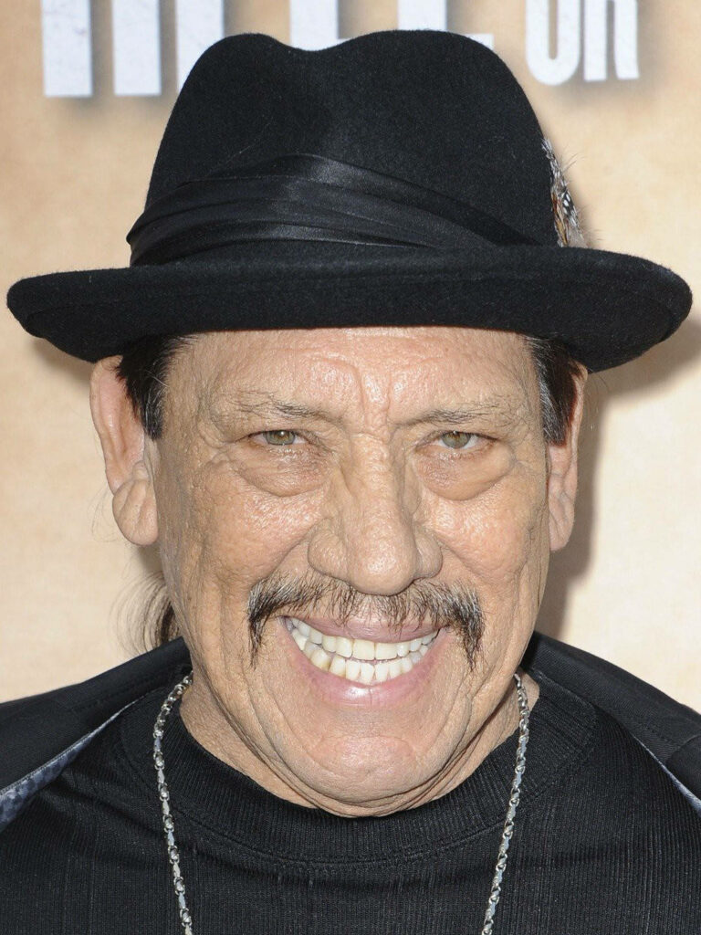 Danny Trejo smiling warmly headshot with distinct mustache rugged charm natural lighting portrait Wallpaper