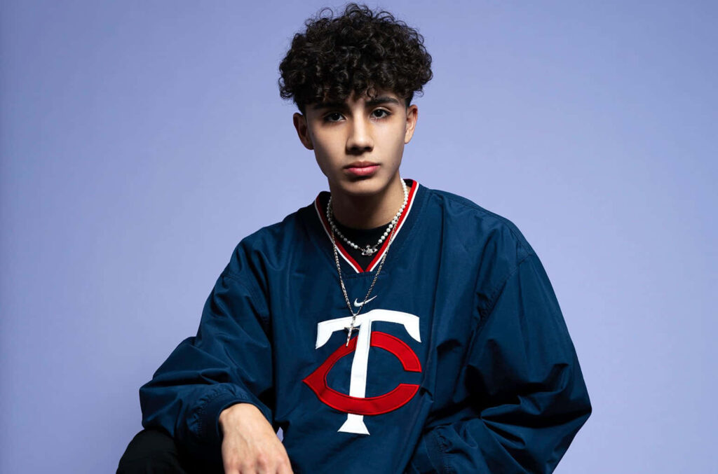 DannyLux wallpaper with singer in blue jacket purple background curly hair youthful music style