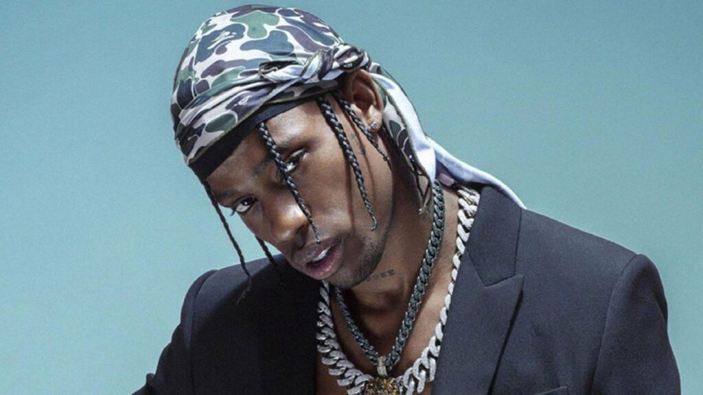 Travis Scott flaunts his cool style in a black overcoat and a headscarf Wallpaper