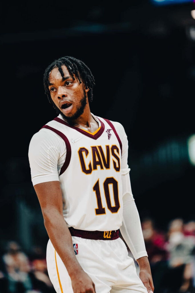 Darius Garland Cleveland Cavaliers focused in white maroon uniform mid-game basketball action wallpaper