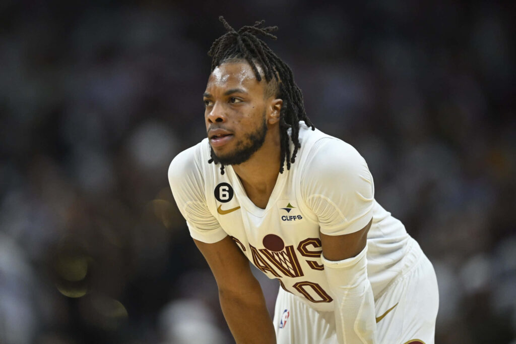 Darius Garland Cleveland Cavaliers intense focus basketball game dynamic sports wallpaper background