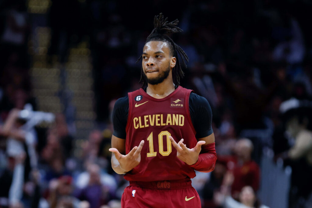 Darius Garland Cleveland Cavaliers deep wine gold jersey focused mid-game basketball action wallpaper