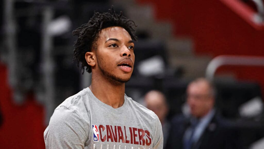 Darius Garland Cleveland Cavaliers warmup shirt focused expression blurred arena background wallpaper