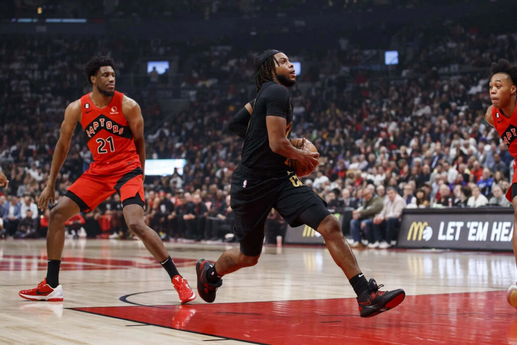 Darius Garland driving to the basket vs Toronto Raptors intense NBA gameplay wallpaper background