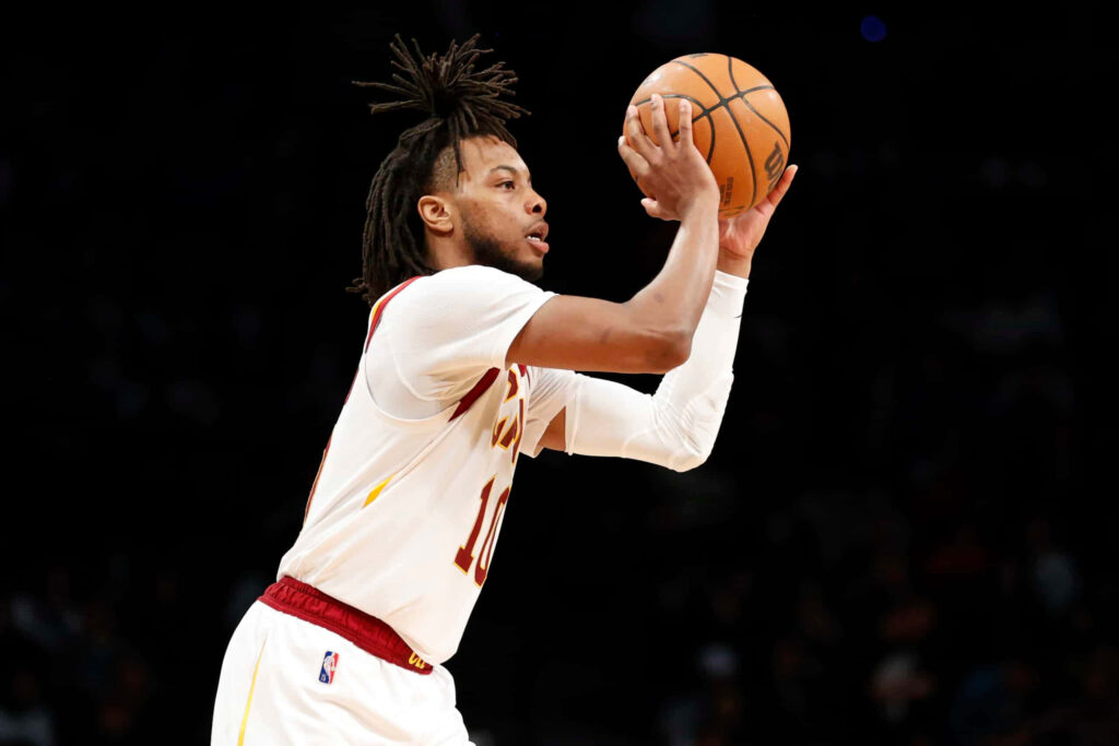Darius Garland focused shooting free throw basketball intense lighting athletic motion wallpaper background