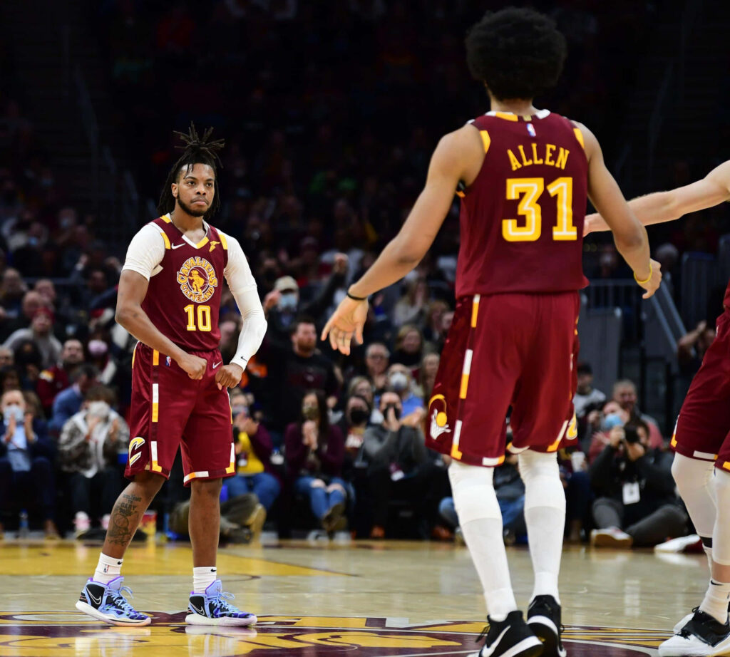 Darius Garland and Jarrett Allen in Cleveland Cavaliers jerseys playing basketball on court teamwork Wallpaper
