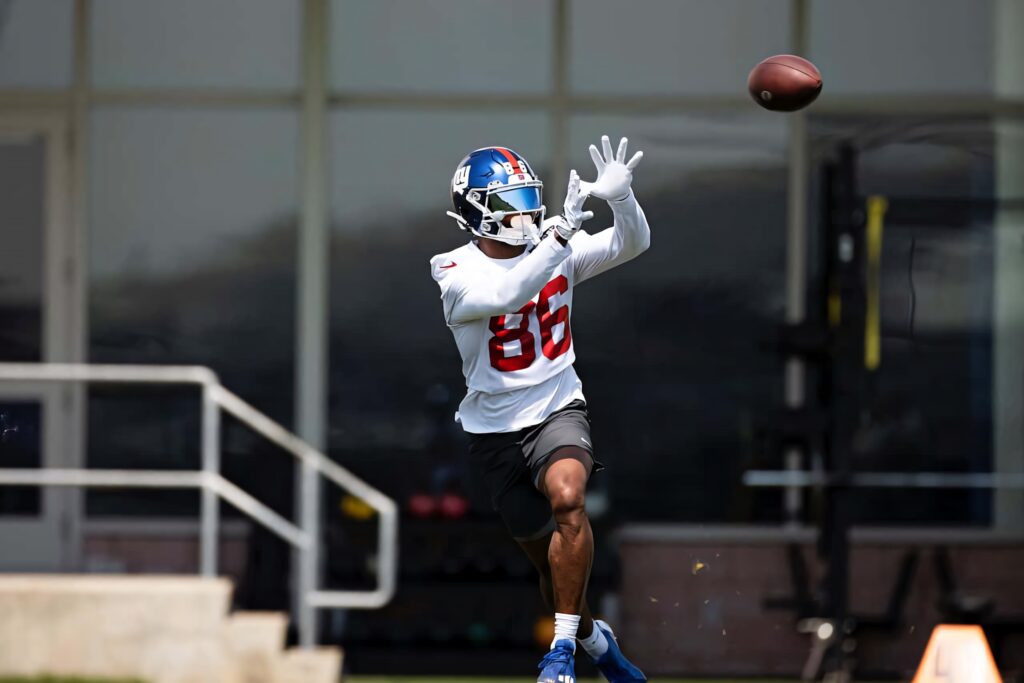Darius Slayton catching football wearing Giants helmet and jersey 86 during practice session Wallpaper