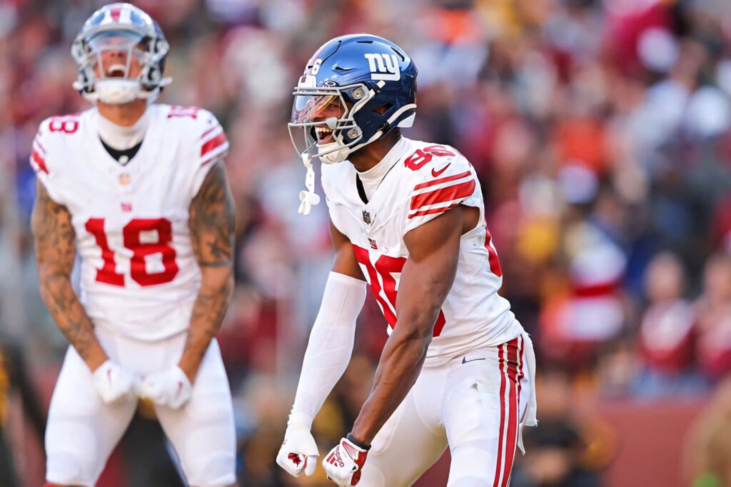 Darius Slayton New York Giants intense NFL action vibrant team colors blurred stadium background Wallpaper