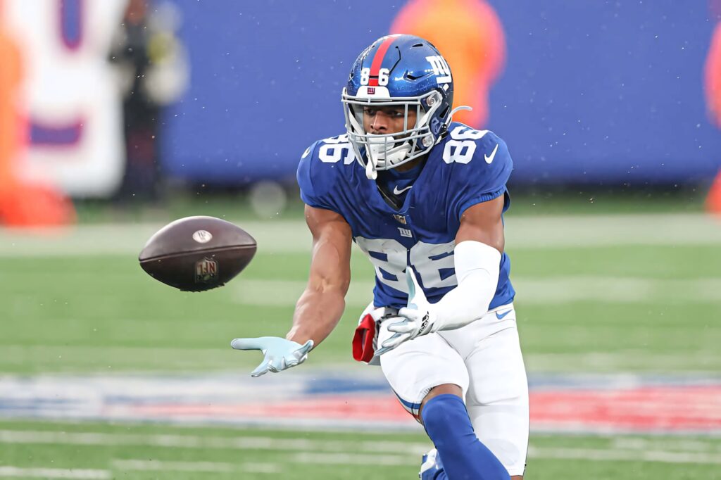 Darius Slayton catching football in blue New York Giants uniform during intense game action wallpaper