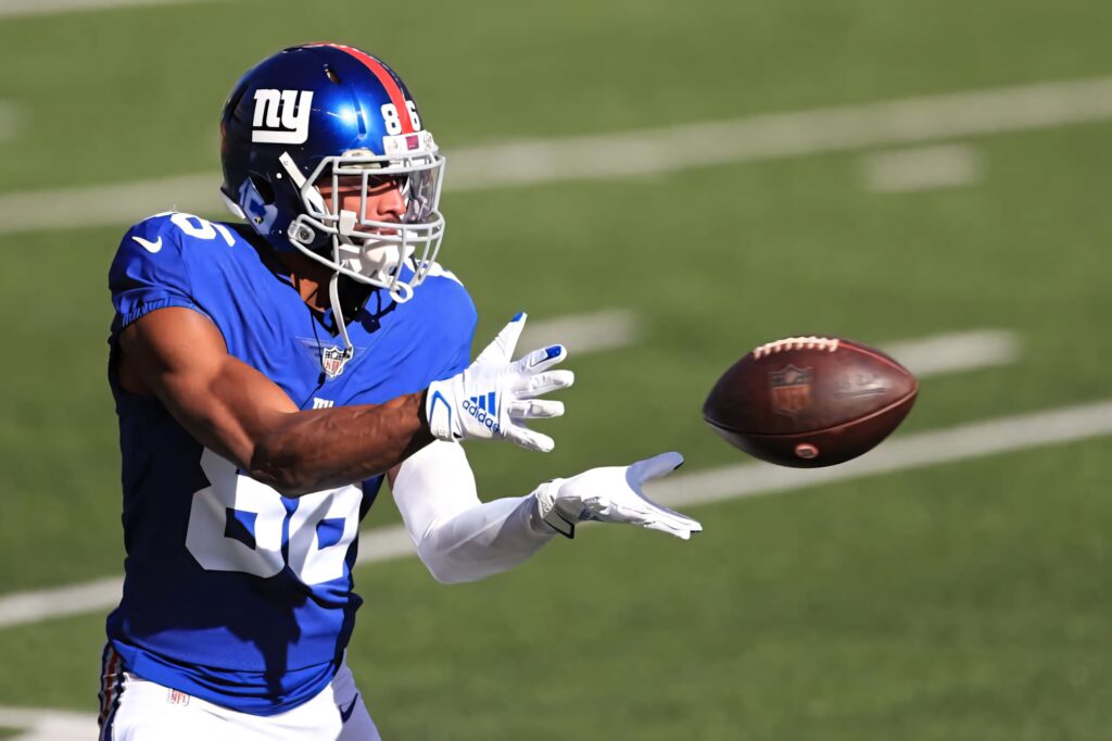 Darius Slayton NFL Giants catching football mid-play on sunlit green field dynamic wallpaper