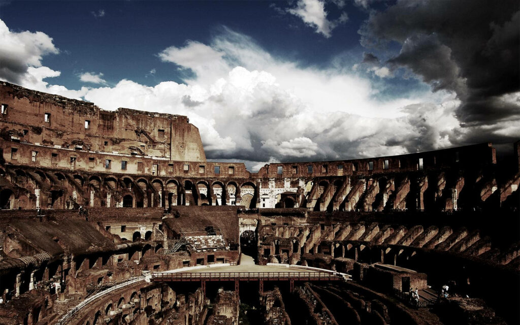 Dark aesthetic Roman Colosseum interior with earthy tones and moody cloud-filled sky wallpaper