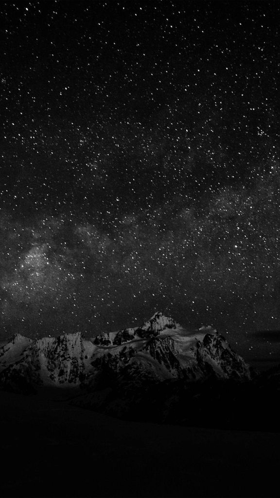 Dark Android wallpaper of monochrome mountains under a vast starry night sky background