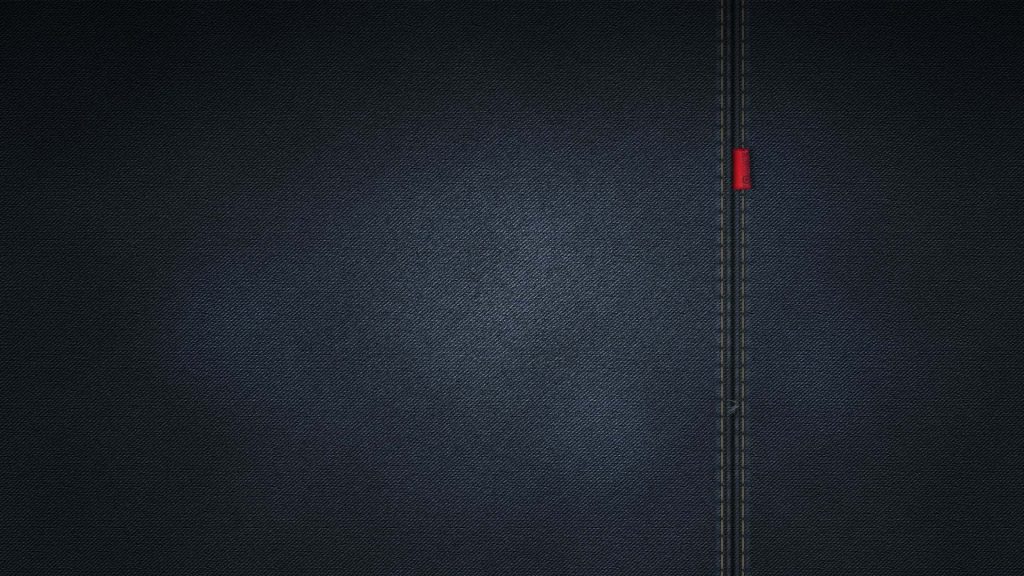 Dark blue denim wallpaper with twill texture vertical stitched seam and red tab background