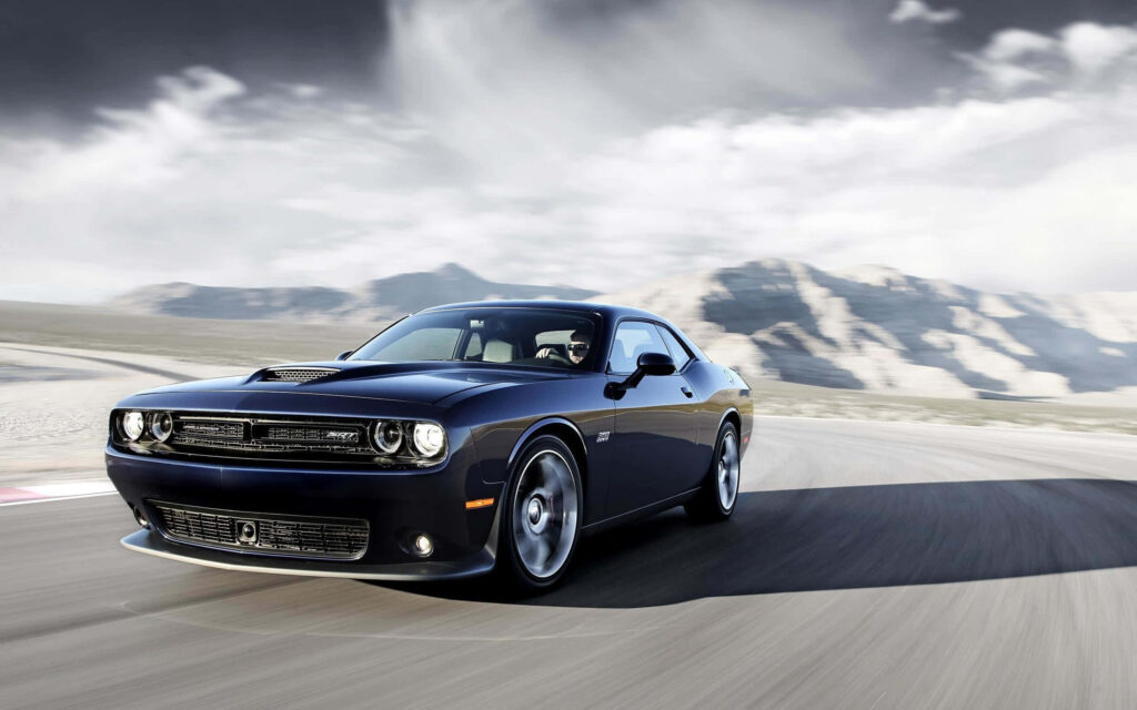 Dark blue Dodge Hellcat speeding on mountain road dynamic car powerful blur background wallpaper