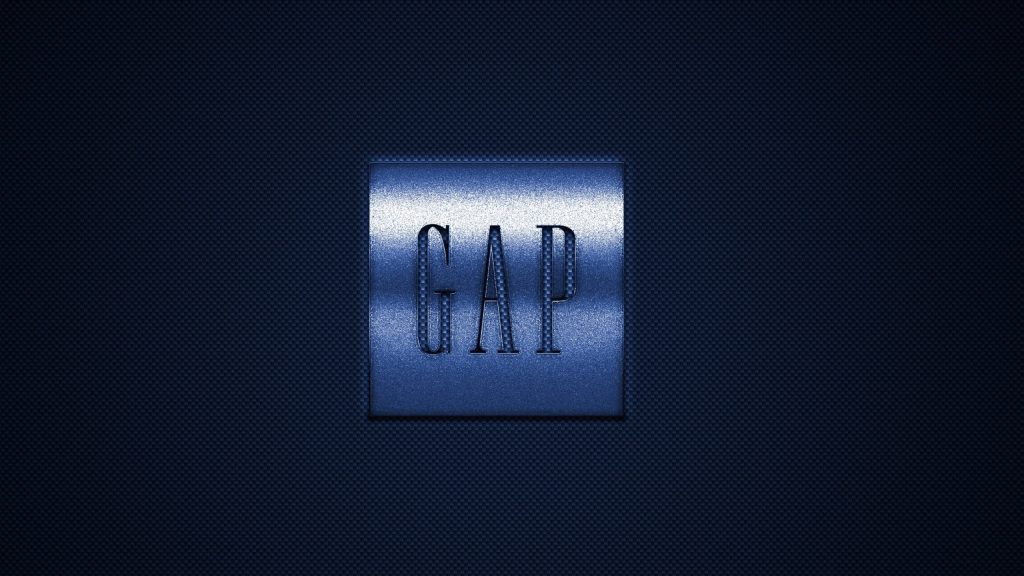 Gap logo embossed on metallic square with navy carbon fiber textured background wallpaper