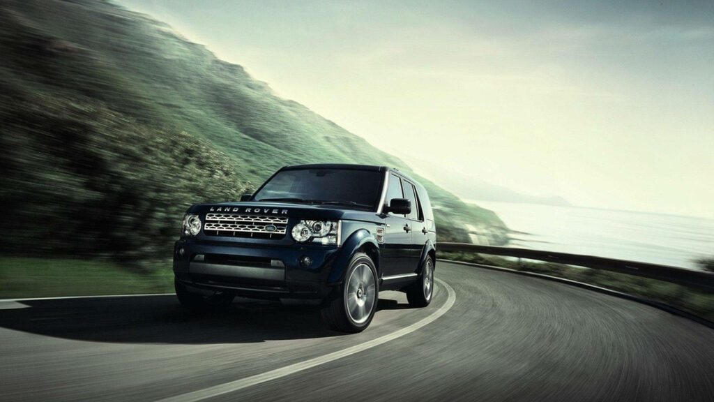Sleek Dark Blue Land Rover Discovery 4: Scenic Adventure Wallpaper