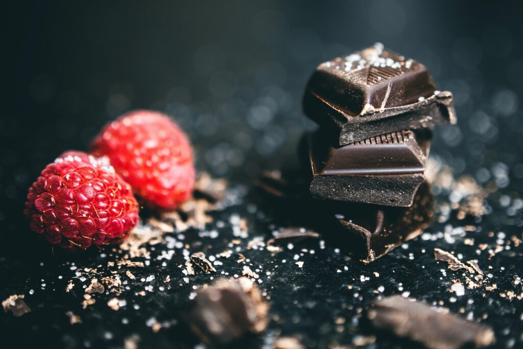 Elegant Dark Chocolate Wedges with Raspberries Wallpaper Background