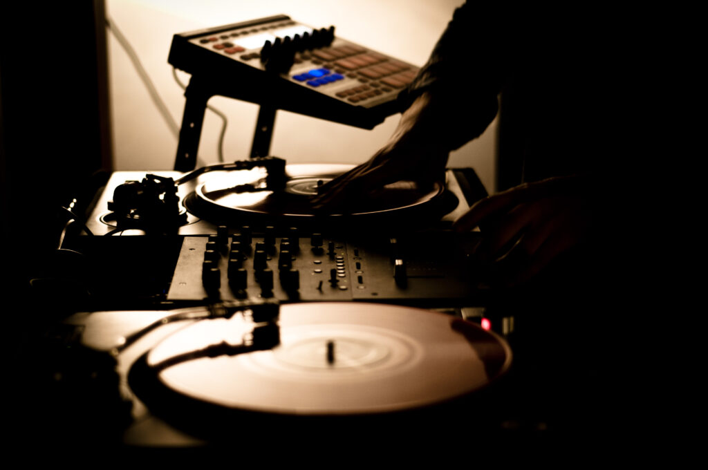 Dark DJ Console Wallpaper: Skillful Mixing Under Soft Lighting