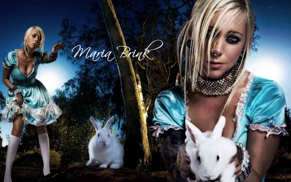 Dark fantasy wallpaper of Maria Brink in blue Alice gown with white rabbit in night forest
