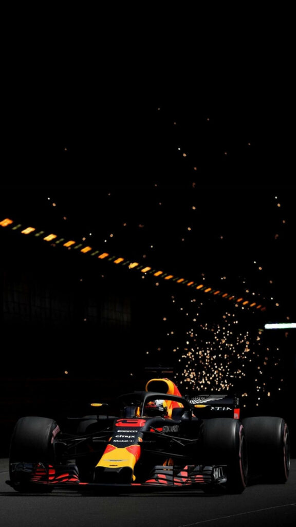 Dark sleek Formula 1 car wallpaper with dramatic sparks on black background speed energy race
