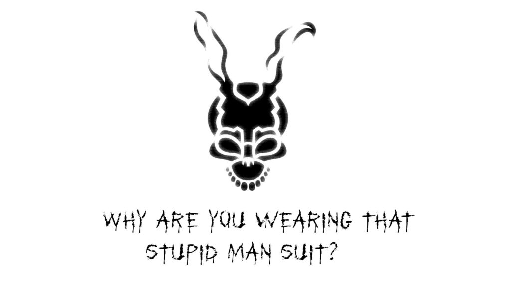 Black skull styled as Frank the Rabbit mask from Donnie Darko with eerie psychological quote wallpaper