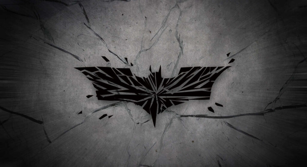 Dark gritty Batman logo shattering cracked concrete background dramatic wallpaper design