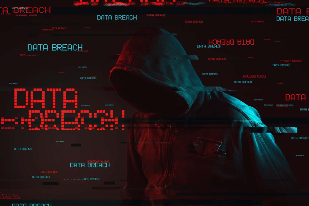 Hooded hacker in glitch digital landscape with data breach text dark cybersecurity wallpaper