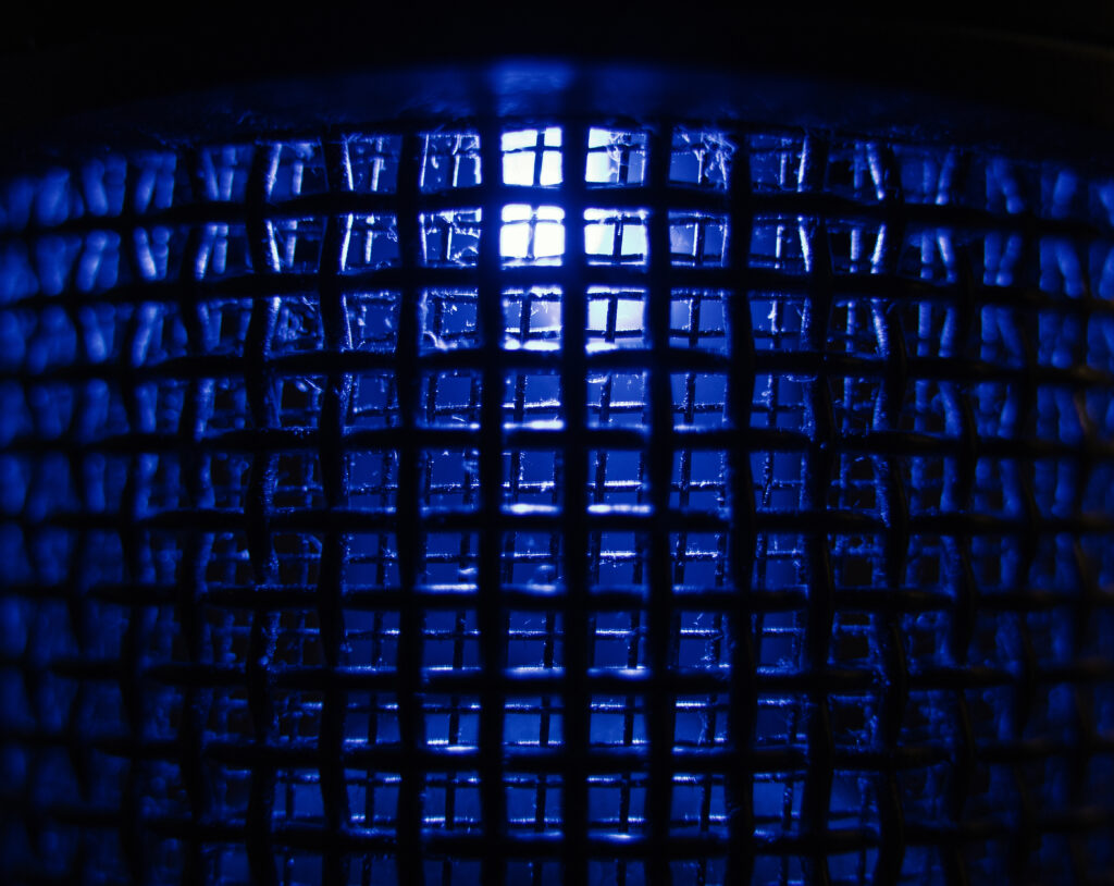 Illuminated Dark Lattice Grid: Striking Blue Light Wallpaper