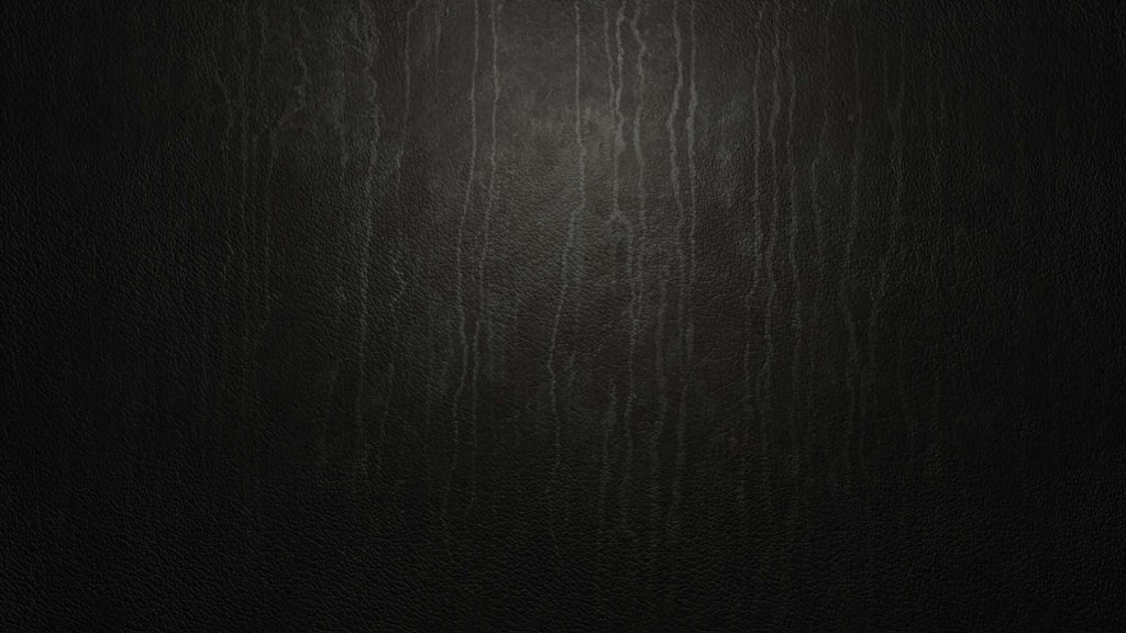 Dark leather desktop wallpaper with charcoal texture and subtle vertical lighting for modern screens