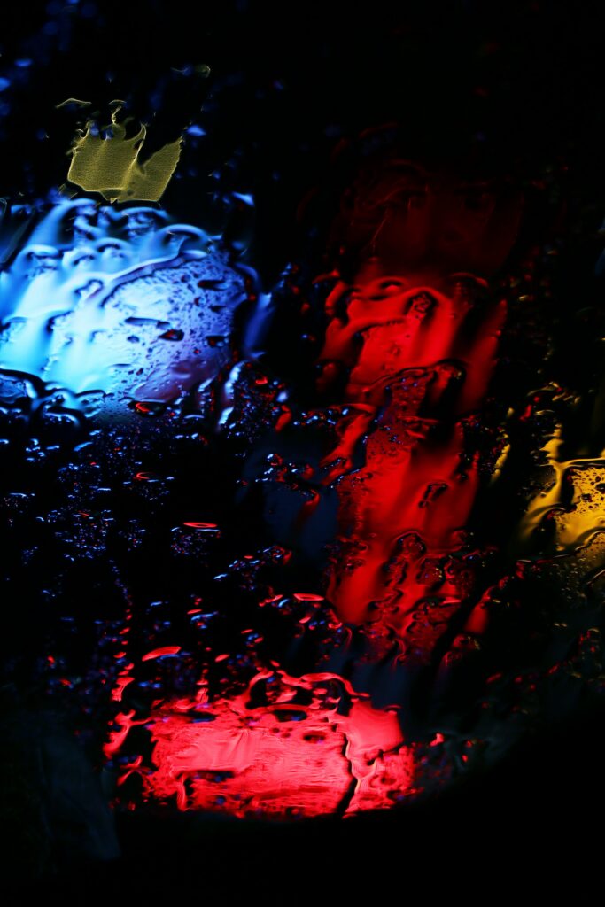 Artistic Dark Wallpaper: Colorful Lights Through Water Drops