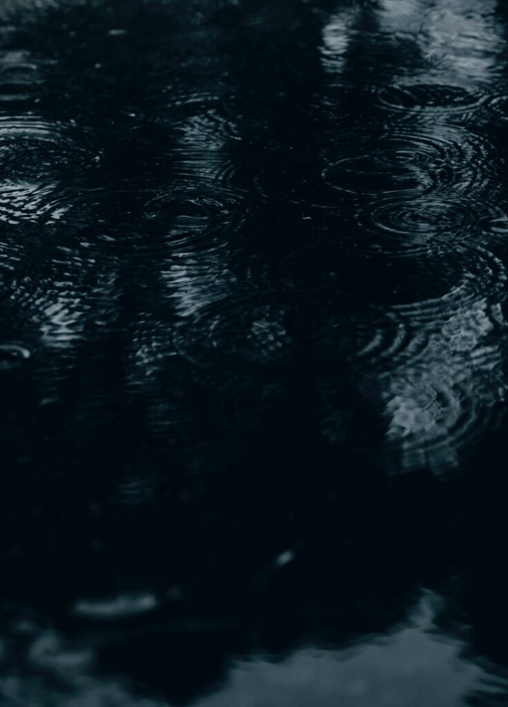 Serene Dark Water Ripple Wallpaper with Raindrops - Moody Background