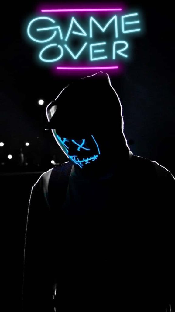 Mysterious figure in hoodie with glowing neon blue LED mask and GAME OVER text wallpaper