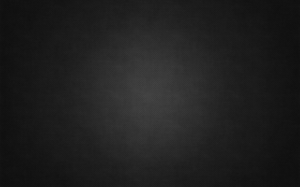 Dark perforated steel mesh texture with soft radial light gradient industrial wallpaper background
