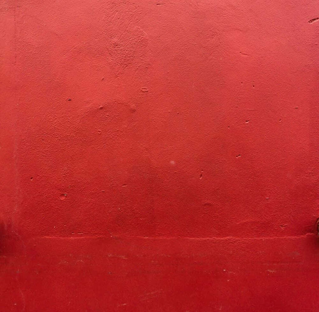 Textured Dark Red Spotty Cement Wallpaper - Rugged Vibrant Aesthetic