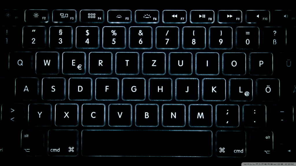 Backlit QWERTZ keyboard with glowing white keys on black for sleek dark mode wallpaper background