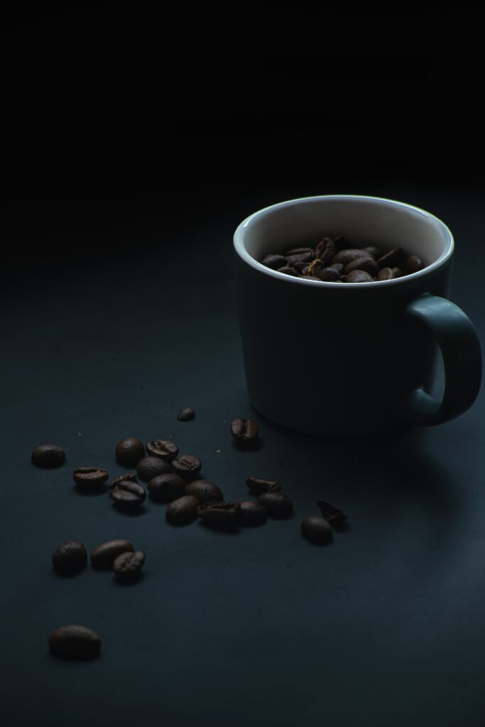 Rich Dark Coffee Wallpaper: Soothing Cup & Bean Design Background