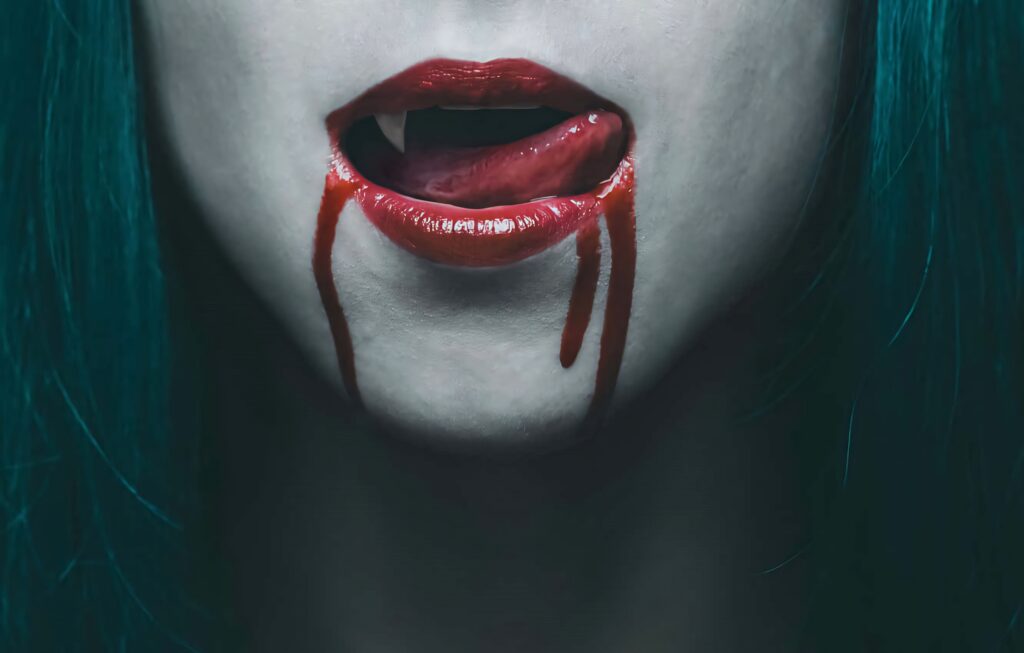 Close-up of vampire mouth with sharp fangs blood red lips and fresh blood dripping dark wallpaper
